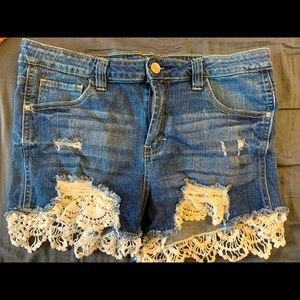 Daisy duke type shirt with lace trim. Cute and sassy!